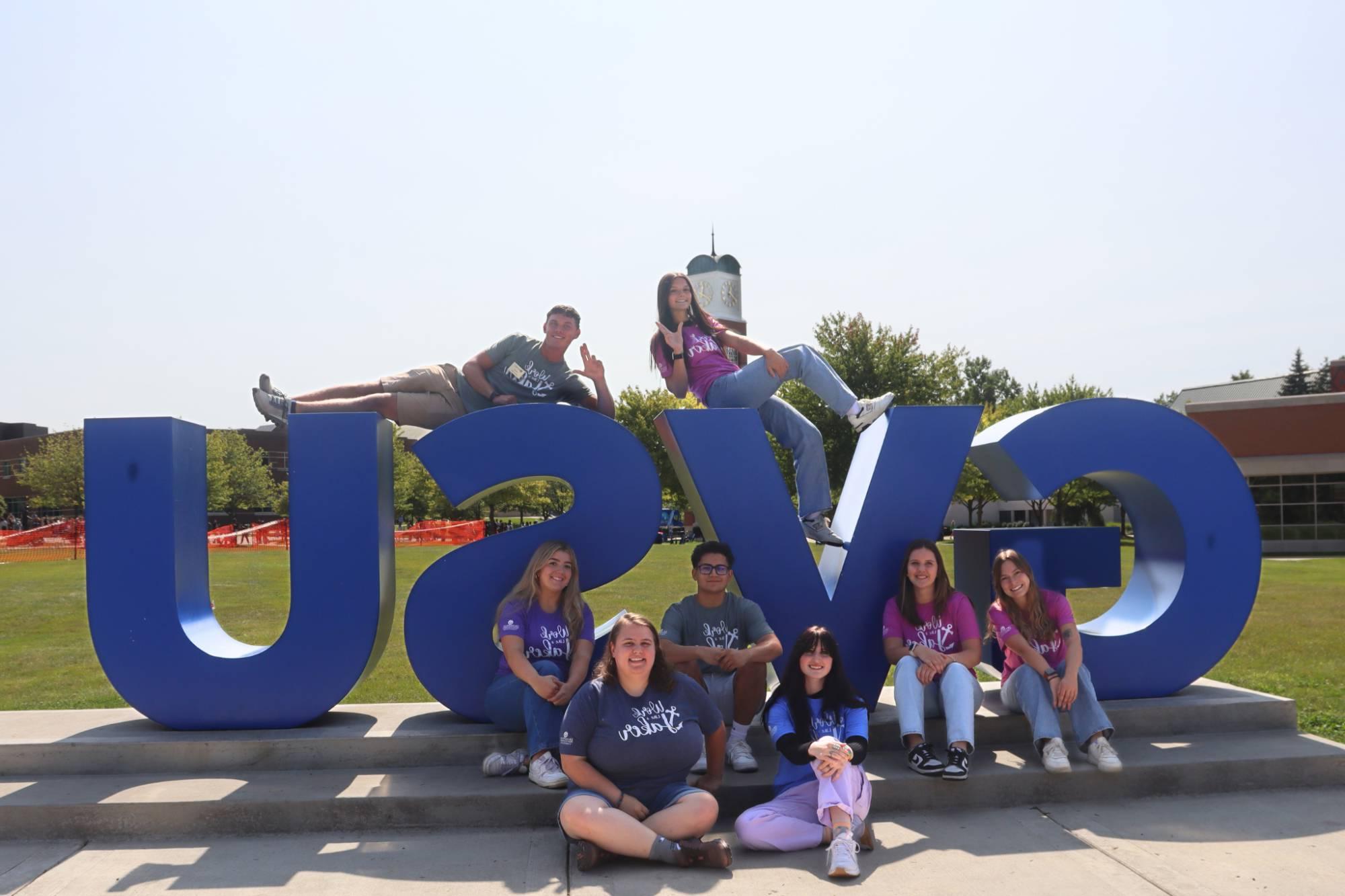 students on gvsu sign